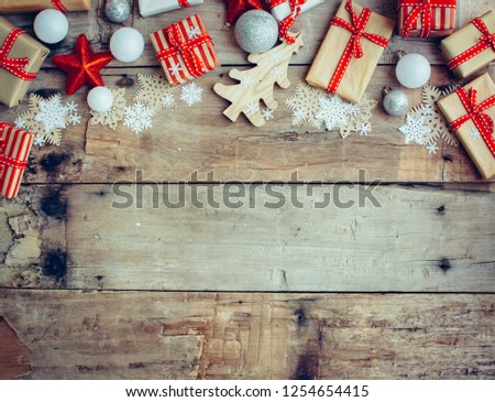 Christmas background with decorations and red gift boxes on the wooden board
