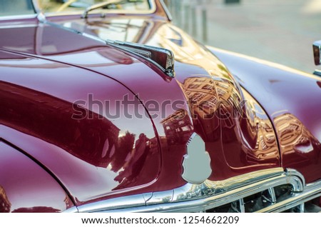 Vintage cars and their elements. Beautiful and stylish front panel and in front of a vintage, old and vintage red retro car from close range.