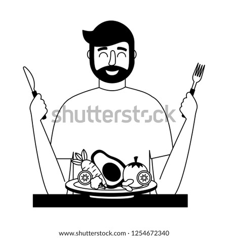 bearded man with fresh vegetable and fork knife