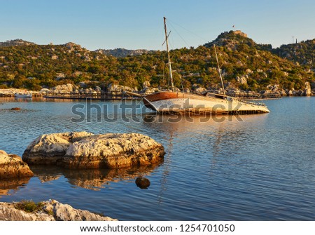 The ship sank in the bay in shallow water in Kekovo, Turkey. Picture at sunset.