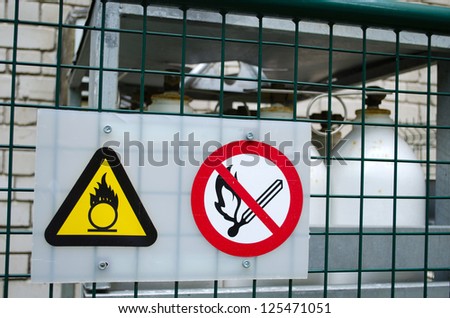 fire warning signs symbol near compressed oxygen gas cylinders. dangerous objects.
