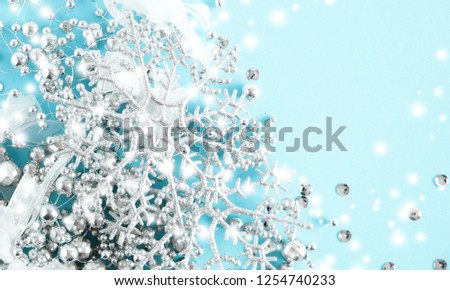Christmas elegant modern composition. Border made of white decorations and snowflakes on pastel blue background. Christmas, New Year, winter concept. Flat lay, top view, copy space