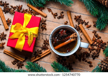 Cup of tea with star anise and cinnamon around Christmas decoration