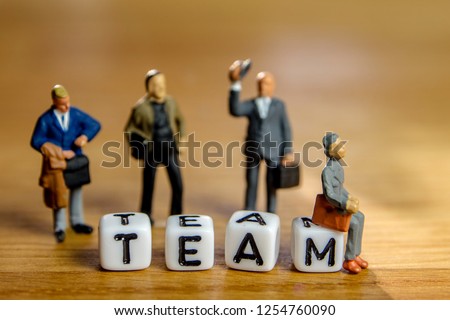 little miniature figurines with little dices forming specific word as a part of team meeting collection pictures dedicated to one part of its time table on wooden background