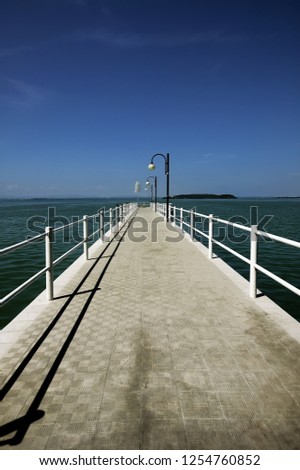 jetty on the Trasimeno one of most great Italian lakes, in the light of morning summer  in the middle Italy, middle Europe. Great image in high resolution vertical sized development