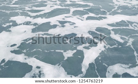 Abstract sea water with white foam. Nature ocean background.  