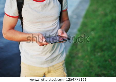 Cropped image of male hands using modern smartphone, millennial typing text message, travel blogger, man working on cellphone, cover page template for website. Social media concept.