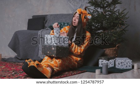 pajamas in the form of a giraffe. emotional portrait of a girl on a gray background. crazy and funny man in a suit. clean skin and long hair. animator for children's parties