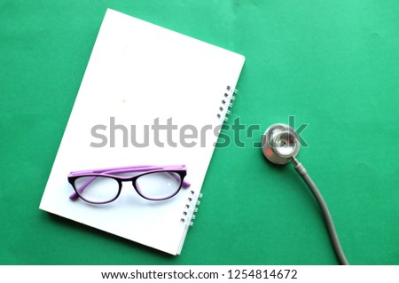  copy text space  doctors office desk medical accessories on green background 