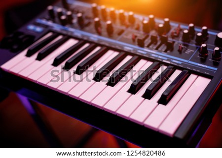 Two octaves electronic musical keyboard synthesizer close-up. Royalty-Free Stock Photo #1254820486