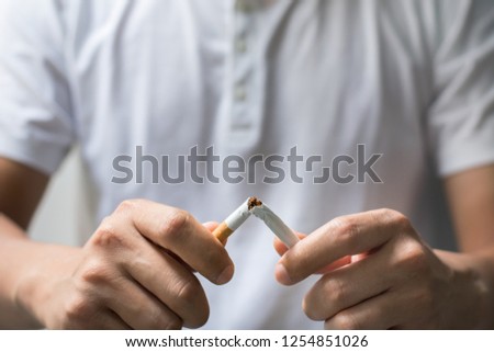 Man hands holding and breaking the cigarette for quit smoking. Stop smoking cigaratte for health concept.