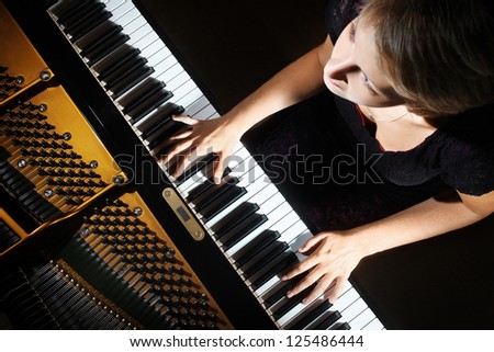 Piano playing pianist player. Woman with musical instrument closeup