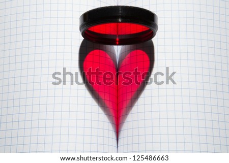 red heart shape & photo-filter on blank writing-book in a section