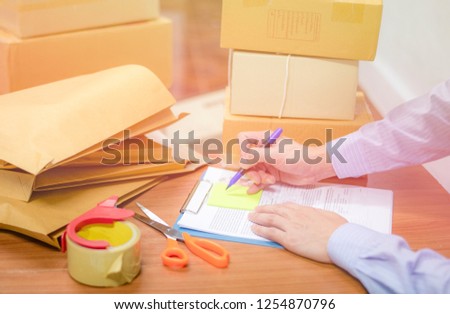 shipping selling things online ecommerce delivery shopping online and order concept / cardboard box parcels and brown envelope on table packing shipping for customer online and hand write on paper