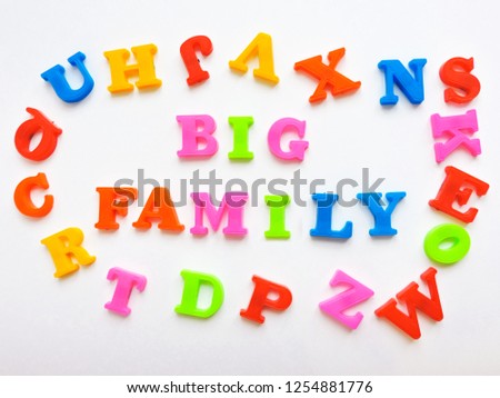  Magnetic Plastic ABC Letters Isolated. Colorful plastic English alphabet on a white  background. Learning english concept.The colorful words "BIG FAMILY  " made with plastic English alphabet.