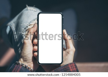 mockup image of cell phone.Businessman at workplace Think business investment plan.Contact Investor using mobile,computer.make note appointment information in the notebook.design creative work space