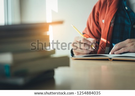 high school,college,university student writing in class room or library at work space with book stack for knowledge prepare exams scholarship study abroad.research world international education learn Royalty-Free Stock Photo #1254884035