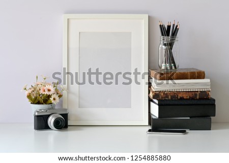 Mockup blank frame poster on hipster workspace