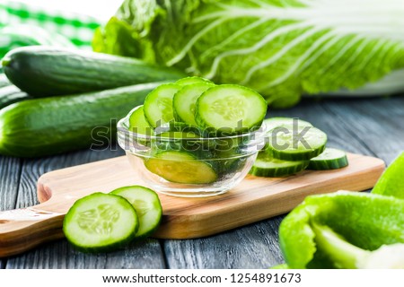 fresh cucumber sliced in a plate on table Royalty-Free Stock Photo #1254891673
