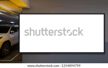 indoor car parking and empty white billboard .Blank space for text and images.