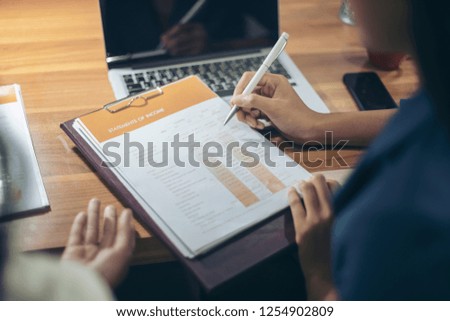 Businessman giving presentation on paper charts to colleagues in office. Business meeting time. Idea presentation, analyze plans.