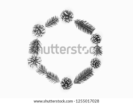 Christmas wreath of pine cones and fir branches isolated on white background. Flat lay, top view, copy space, black and white photo