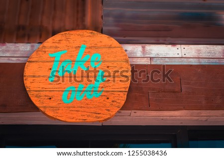 Artistic design wooden take out signage above the counter of a fast food store