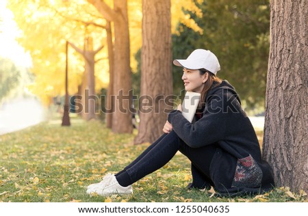 Beautiful Asian women in autumn Parks