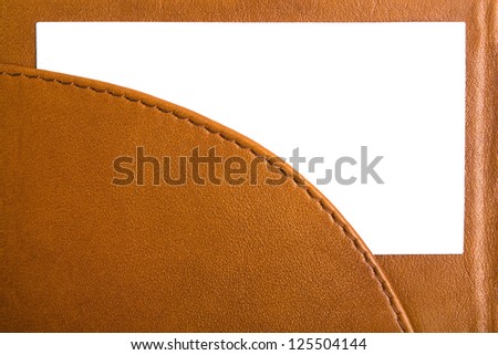 Sample business card in open leather holder isolated on white background