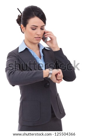 smiling  business woman checking time while talking on cellphone over white background