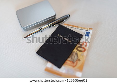 Euro moneys with pen and lawyer patent badge. Ordine Avvocati means Barde of lawyers