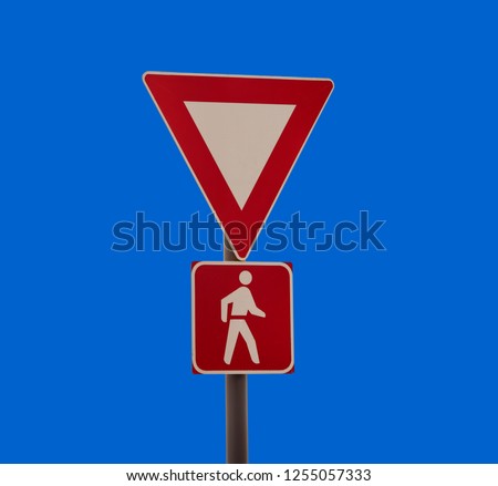 give way traffic sign isolated on blue sky
