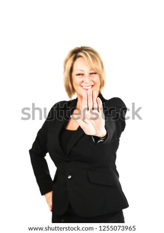 Confident middle aged business woman doing a stop gesture with her hand against a white background