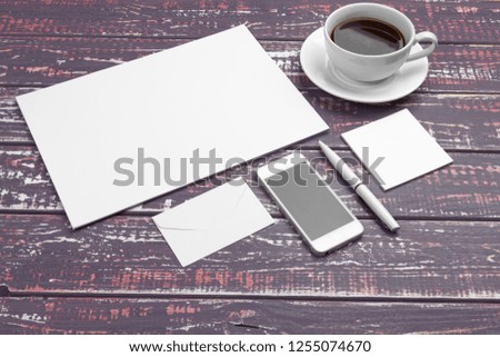 Branding stationery mockup on purple desk. Top view of paper,  business card, pad, pens and coffee.