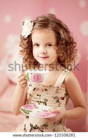 Little cute and sweet girl with tea