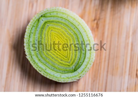 Closeup of fresh leek slices on a table with view from above