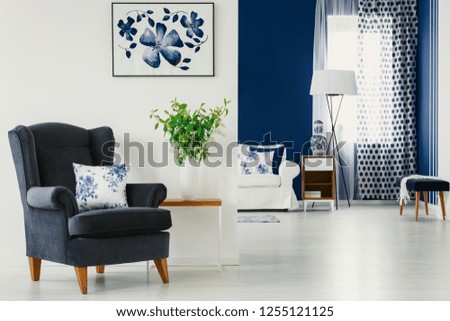 White and blue design in contemporary living and dining room of classy apartment, real photo with mockup on white wall