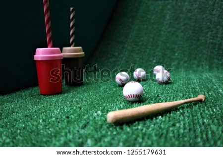 Baseball and bat on the  green grass with copy space
