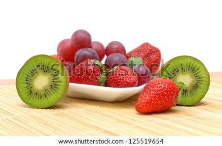 ripe juicy berries and fruits. kiwi, strawberries and grapes on a white background