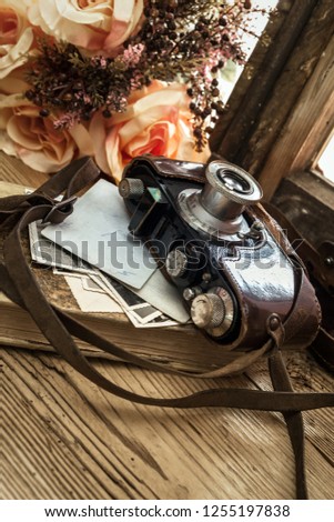 
still life with camera and old vintage photographs