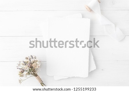 Feminine wedding, birthday desktop mock-up. Invitation card mockup, template Blank greeting cards, rspv card, 5x7, card, envelope. White silk ribbons, dry flowers. White wooden background. Flat lay