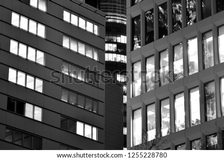 Modern office building at night. Night lights, city office building downtown, cityscape view. Black and white.