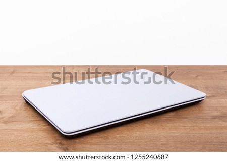Computer isolated on wooden background.