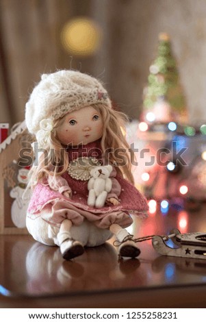 Small doll and Sledge on the background of lights