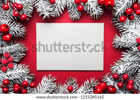 Merry Christmas and Happy Holidays greeting card, frame, banner. New Year. Noel. Silver, white and red Christmas ornaments and fir tree on red background top view. Winter holiday xmas theme. Envelope.