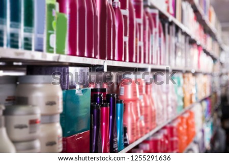 Picture of showcase with bottles of shampoos and conditioners in the hair care store.