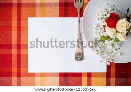 Festive table setting with flowers and vintage crockery on the bright checkered tablecloth in a country style, card template