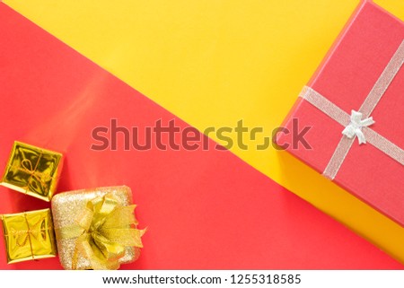 Christmas present red gifts box and decorating elements on red and yellow background. Top view and copy space. Christmas decorations, Christmas, winter, Happy new year concept.