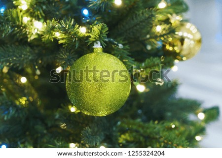Front view Christmas card. Christmas tree picture. Bright sparkling green ball on fluffy branches Christmas tree. Background bokeh lights garland. Ready Christmas background. Happy New Year. Glitter
