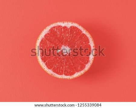 Color of year 2019 Living Coral concept. Grapefruit half on living coral background. Top view or flat lay. Copy space for text. Royalty-Free Stock Photo #1255339084